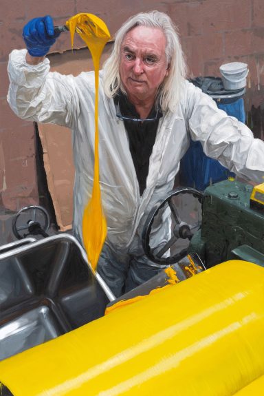 Chasing perfection through colour - portrait of Michael Harding Portrait by Oliver Winconek of Michael Harding mixing oil yellow paint at the colour mill in Wales. He is wearing a white boiler suit.