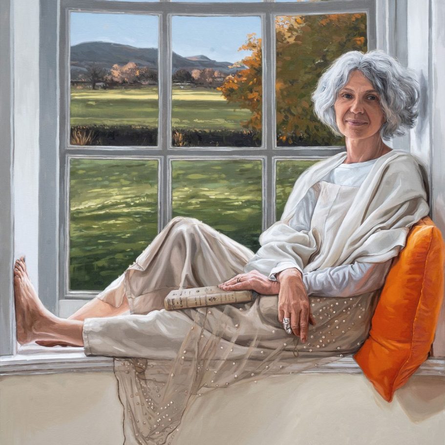 Oil painting of a Stylish woman with grey hair sitting on a windowsill, smiling, with a book on her lap and a Yorkshire view behind her.