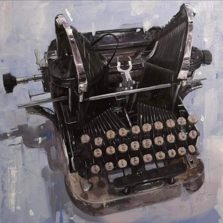 Vintage black typewriter on a textured light background.