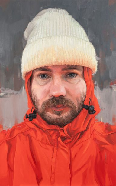 Portrait of a modern artist - Tom Guilmard Portrait of a person in an orange jacket and white beanie against a muted background. By Oliver Winconek, contemporary portrait artist.