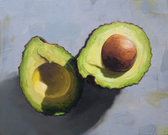 Oil painting of a sliced avocade showing the stone, half of the avocado is in shadow