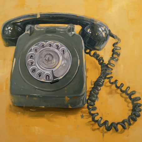 Vintage rotary phone with a coiled cord against a yellow background.