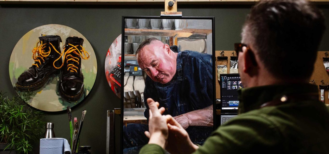 UK Portrait artist Oliver Winconek in his studio working on an oil painted portrait commission.